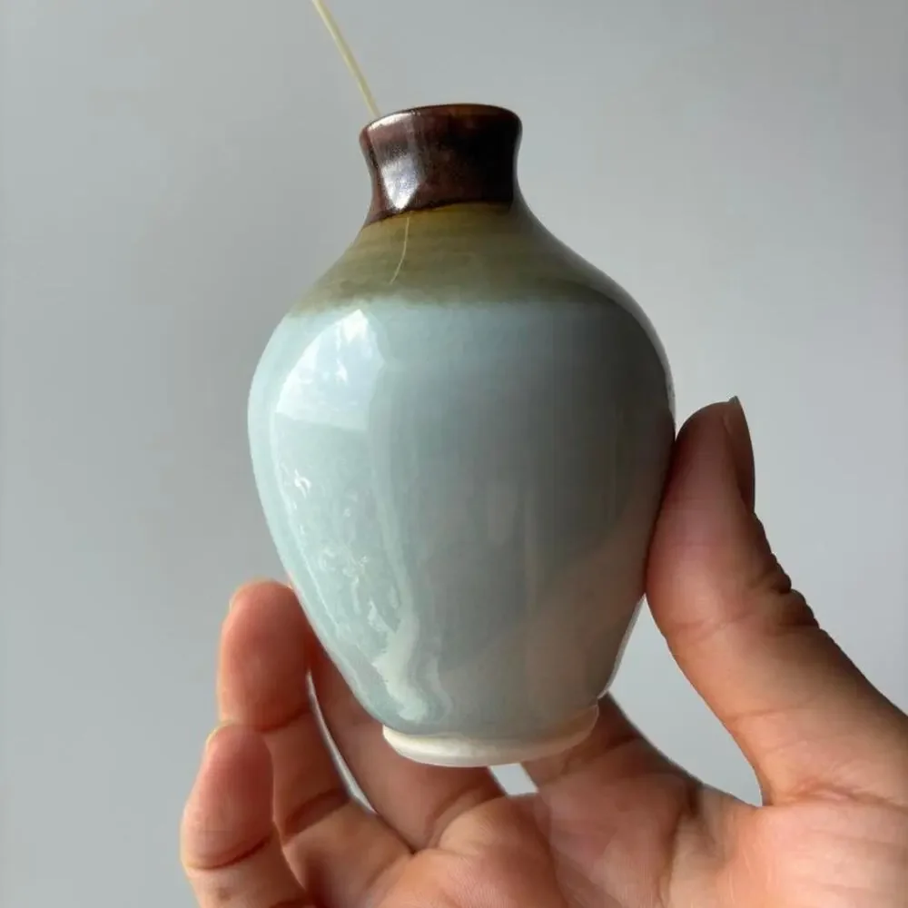 Signed studio pottery bud vase with pale blue celadon-style glaze